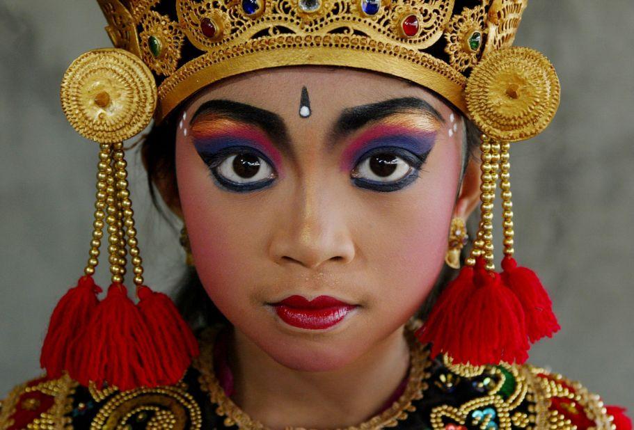 <strong>Time for traditions:</strong> A Balinese dancer poses in her traditional costume before a performance. Music, dance and drama are an essential part of Balinese culture. Legong dance is the center of classical female Balinese dancing, incorporating no less than 92 movements.
